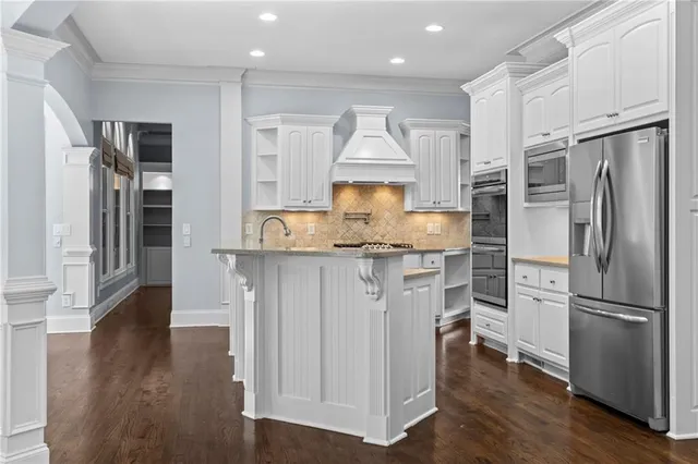 an empty room with chandelier fan