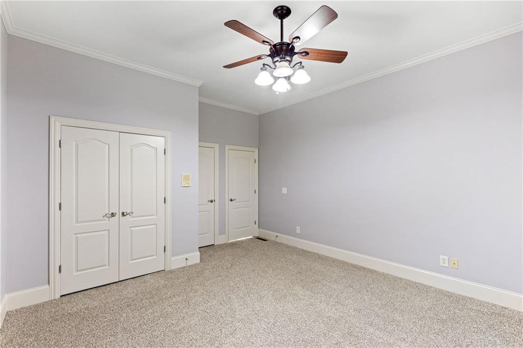 3302 Anna Ruby Lane Northeast Buford, GA 30519 - Photo 25 of 67 an empty room with chandelier fan