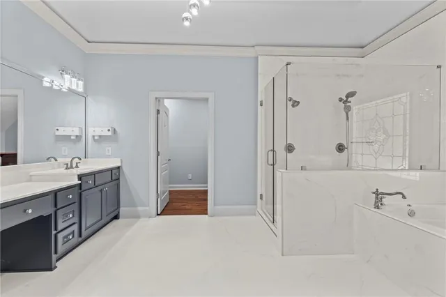 an empty room with wooden floor and ceiling fan