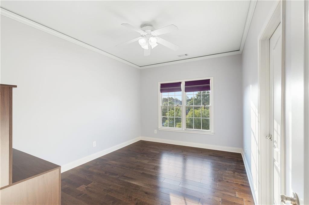 3302 Anna Ruby Lane Northeast Buford, GA 30519 - Photo 36 of 67 an empty room with wooden floor and windows