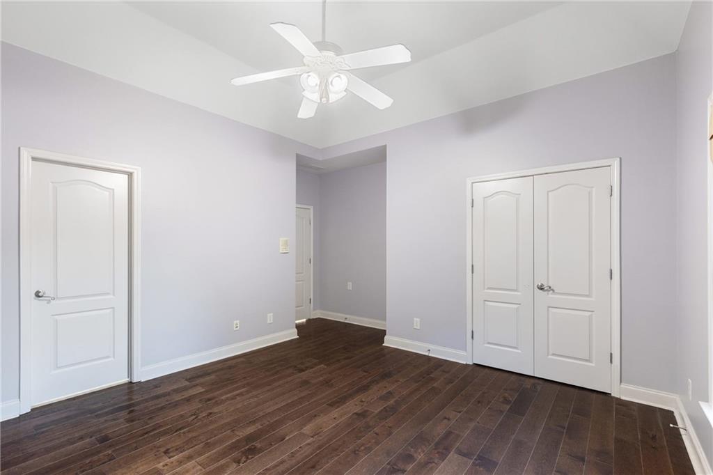 3302 Anna Ruby Lane Northeast Buford, GA 30519 - Photo 44 of 67 an empty room with wooden floor and ceiling fan