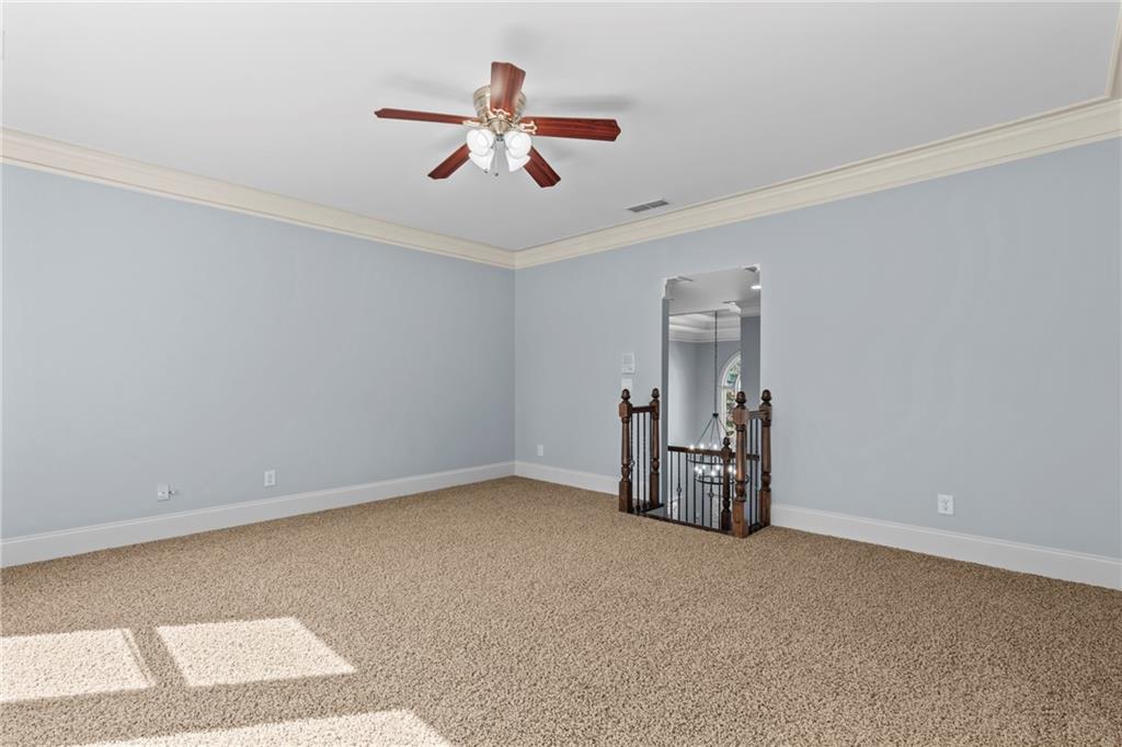 3302 Anna Ruby Lane Northeast Buford, GA 30519 - Photo 46 of 67 a view of an empty room with chandelier fan and windows