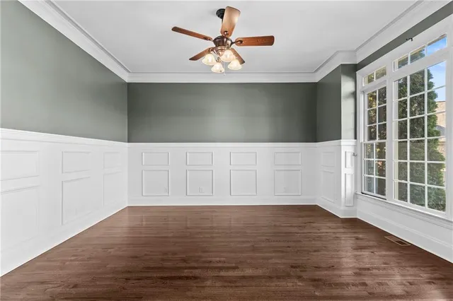 a view of a livingroom with wooden floor fireplace and windows