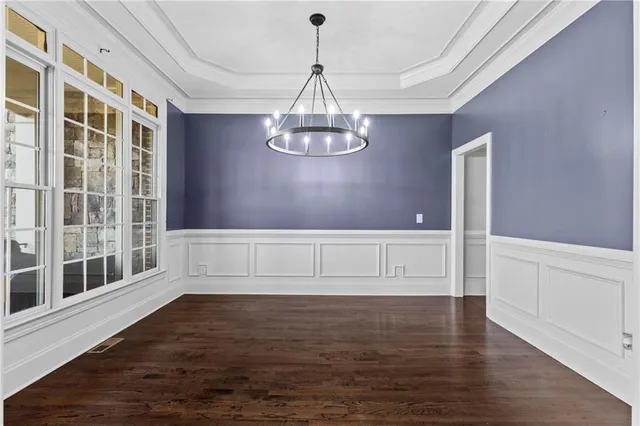 a view of empty room with wooden floor and fireplace