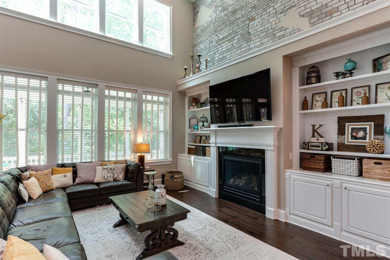 8105 Greys Landing Way Raleigh, NC 27615 - Photo 11 of 30 a living room with furniture a flat screen tv and a fireplace
