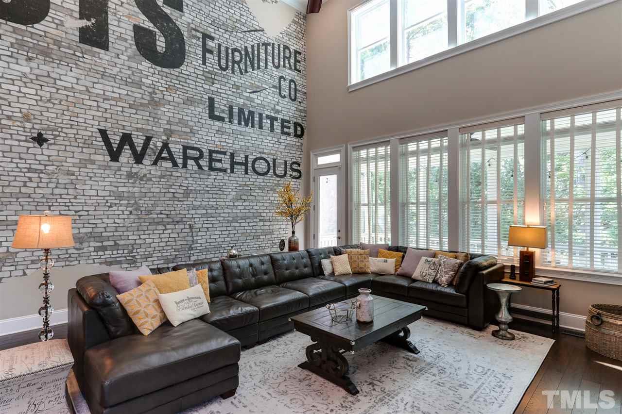 8105 Greys Landing Way Raleigh, NC 27615 - Photo 12 of 30 a living room with furniture and a floor to ceiling window