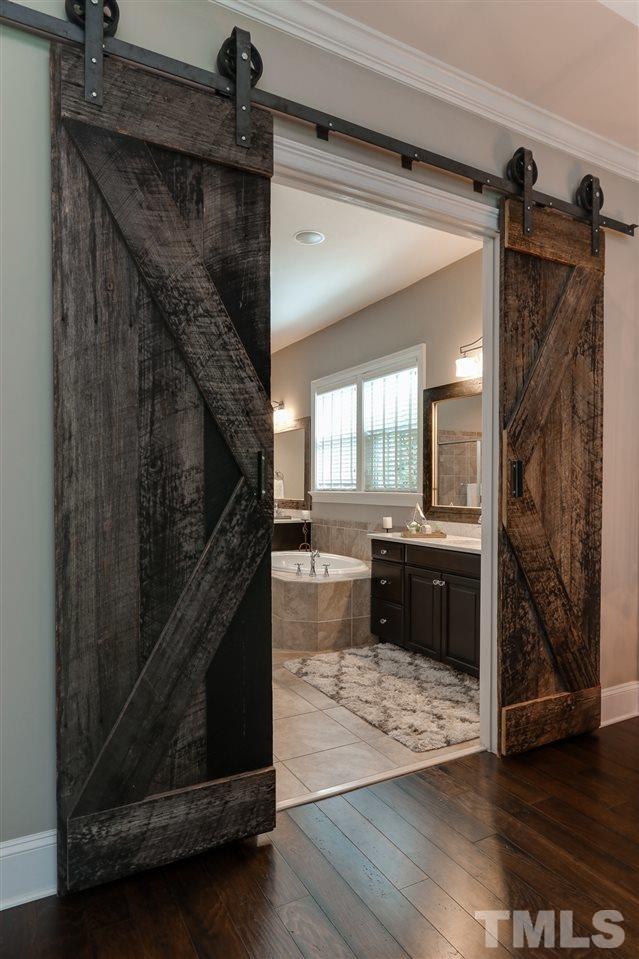8105 Greys Landing Way Raleigh, NC 27615 - Photo 14 of 30 a view of a hallway view with wooden floor and staircase