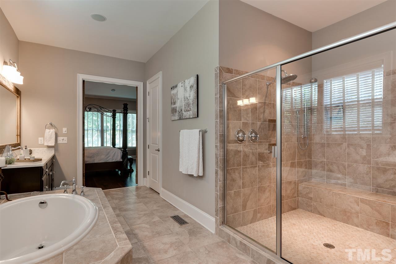 8105 Greys Landing Way Raleigh, NC 27615 - Photo 16 of 30 a bathroom with a bathtub and a shower