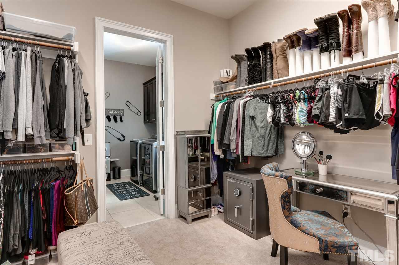 8105 Greys Landing Way Raleigh, NC 27615 - Photo 17 of 30 a view of walk in closet with clothes and shoes