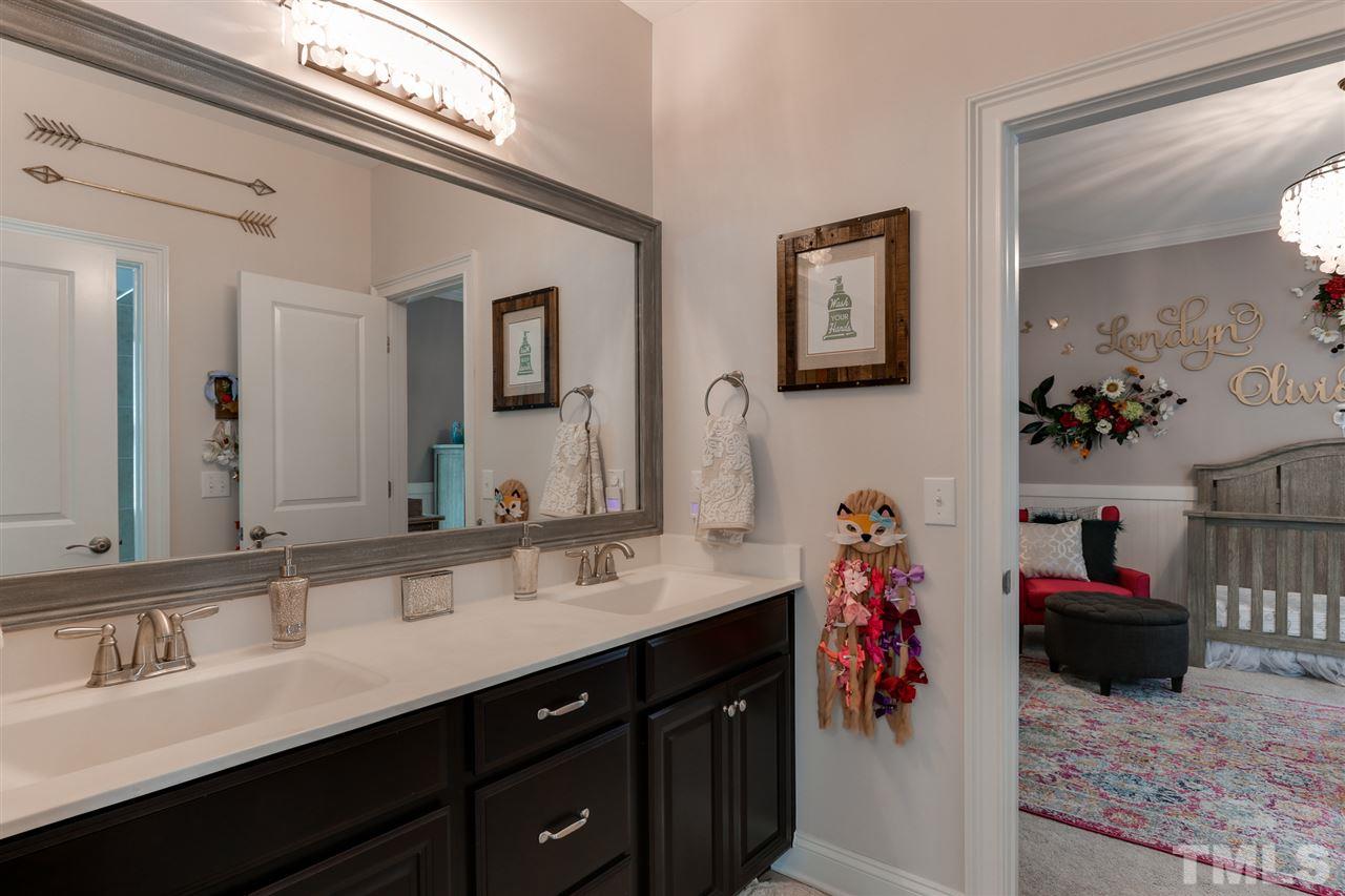 8105 Greys Landing Way Raleigh, NC 27615 - Photo 22 of 30 a bathroom with a sink and a mirror