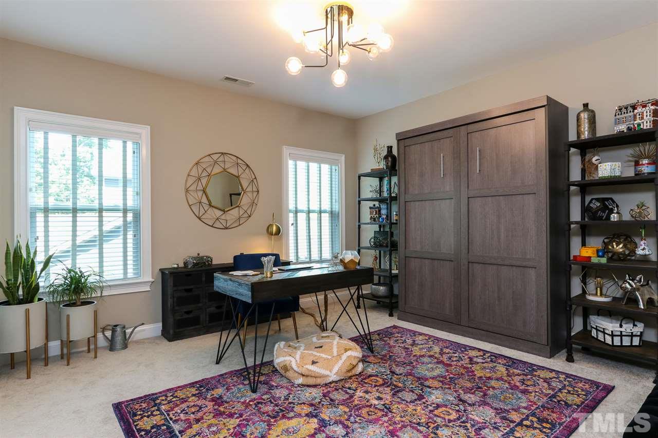 8105 Greys Landing Way Raleigh, NC 27615 - Photo 24 of 30 a living room with a couch and a table
