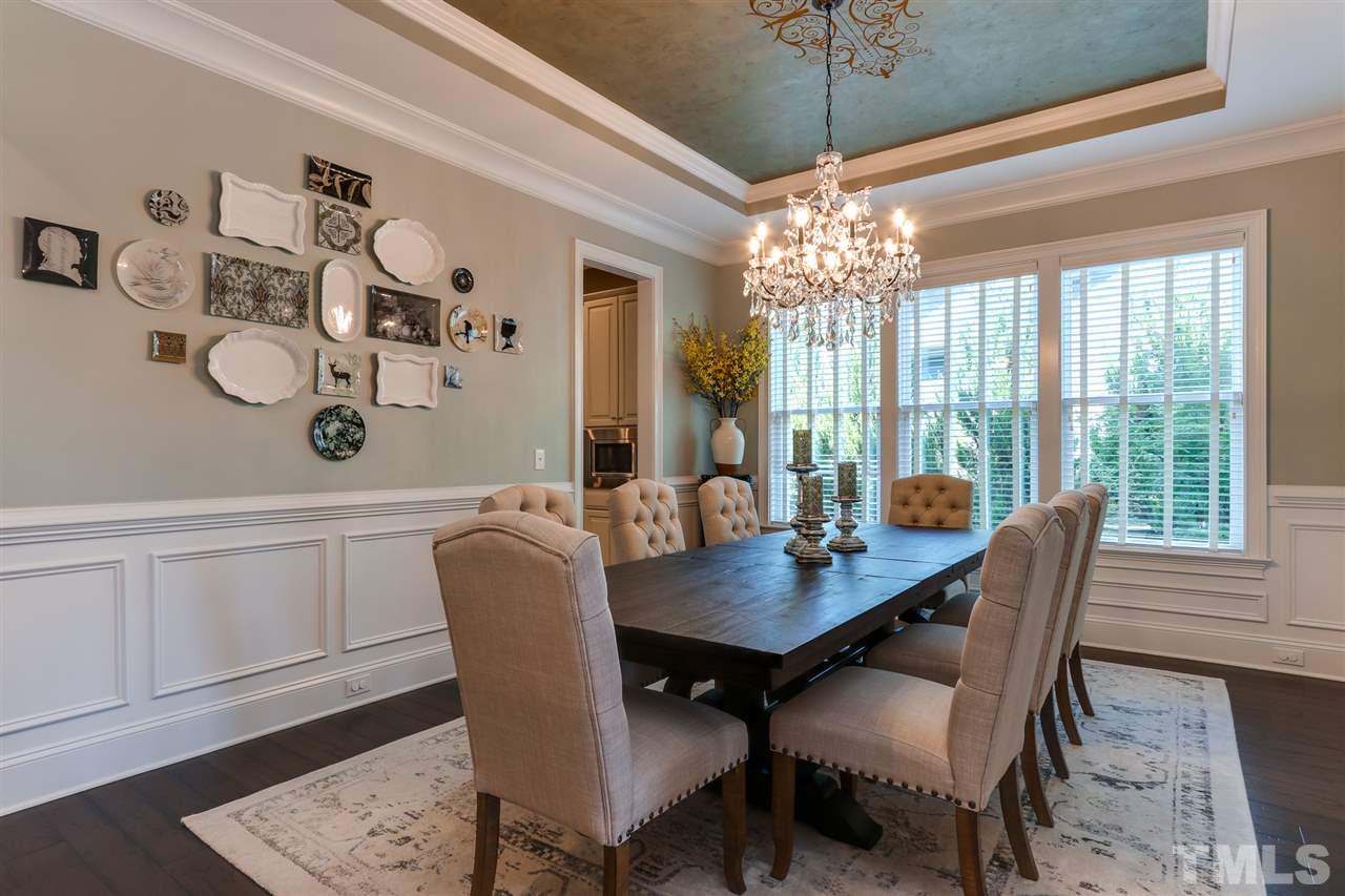 8105 Greys Landing Way Raleigh, NC 27615 - Photo 5 of 30 a dining room with furniture a chandelier and window