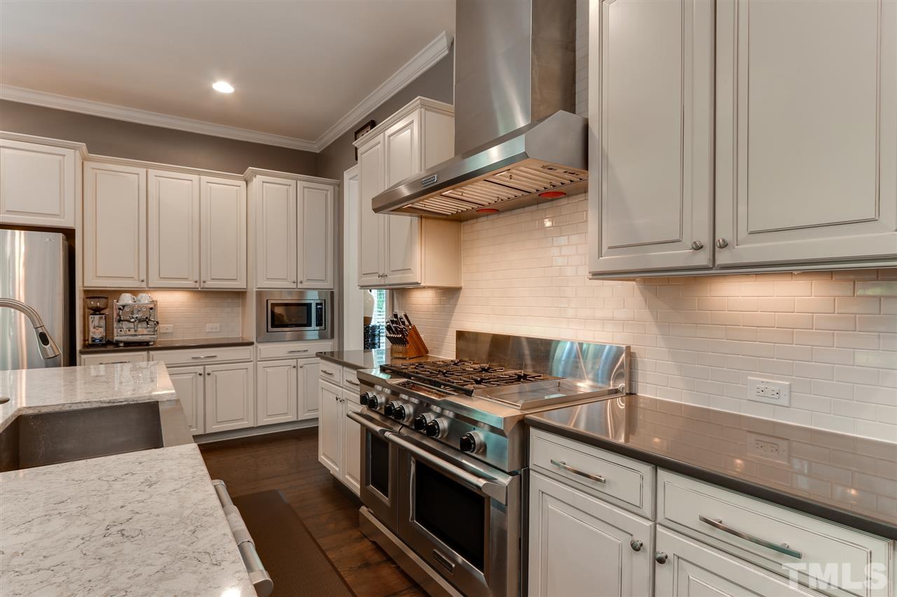 8105 Greys Landing Way Raleigh, NC 27615 - Photo 8 of 30 a kitchen with stainless steel appliances granite countertop a sink a stove and cabinets