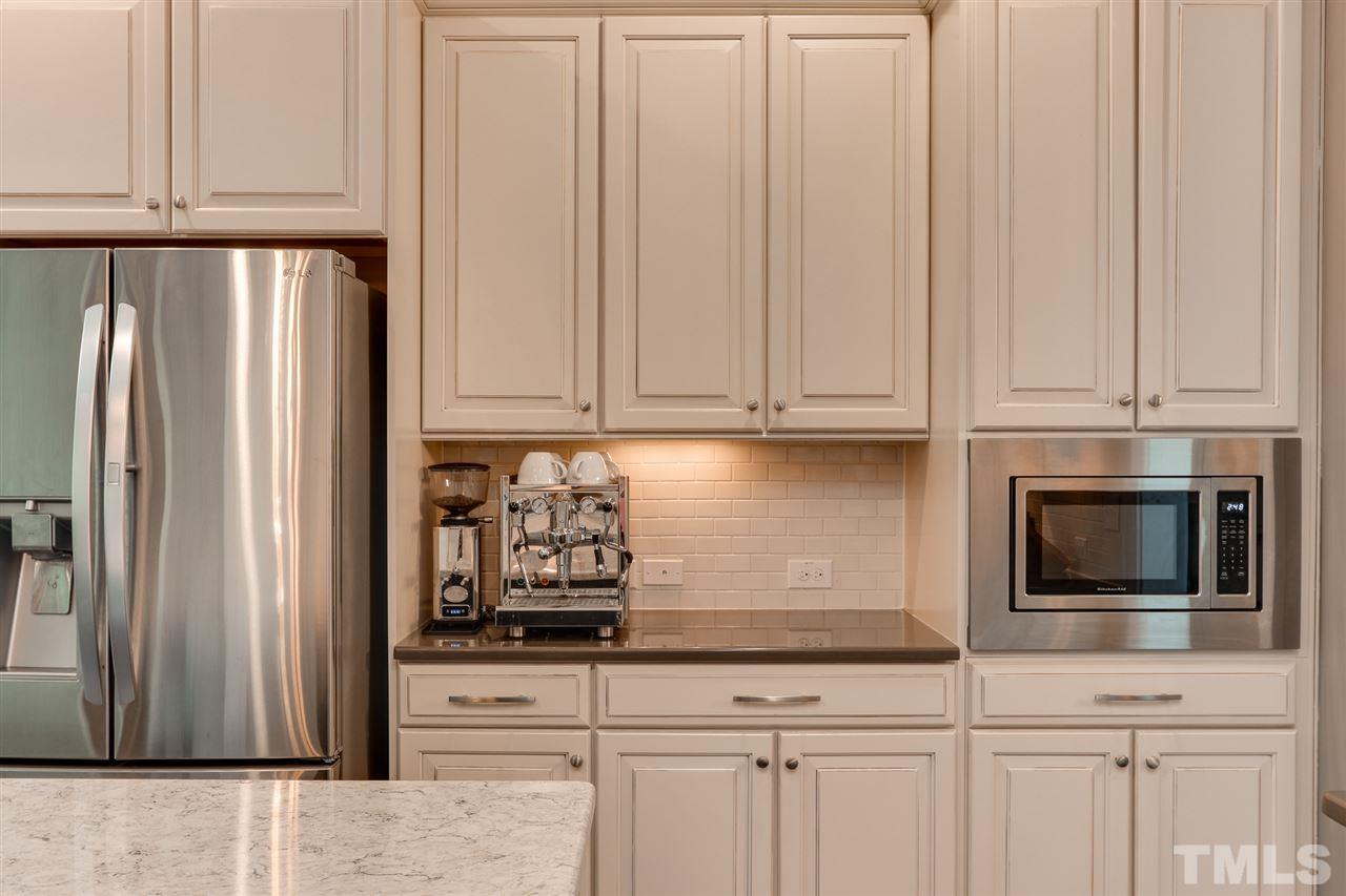 8105 Greys Landing Way Raleigh, NC 27615 - Photo 9 of 30 a kitchen with stainless steel appliances white cabinets and a refrigerator