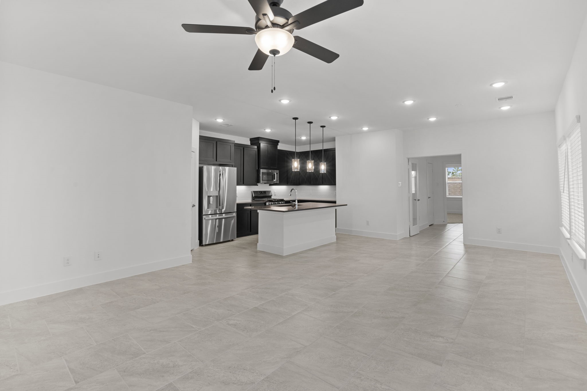 5231 Celestial Court Iowa Colony, TX 77583 - Photo 13 of 37 a view of a kitchen with a refrigerator and a ceiling fan