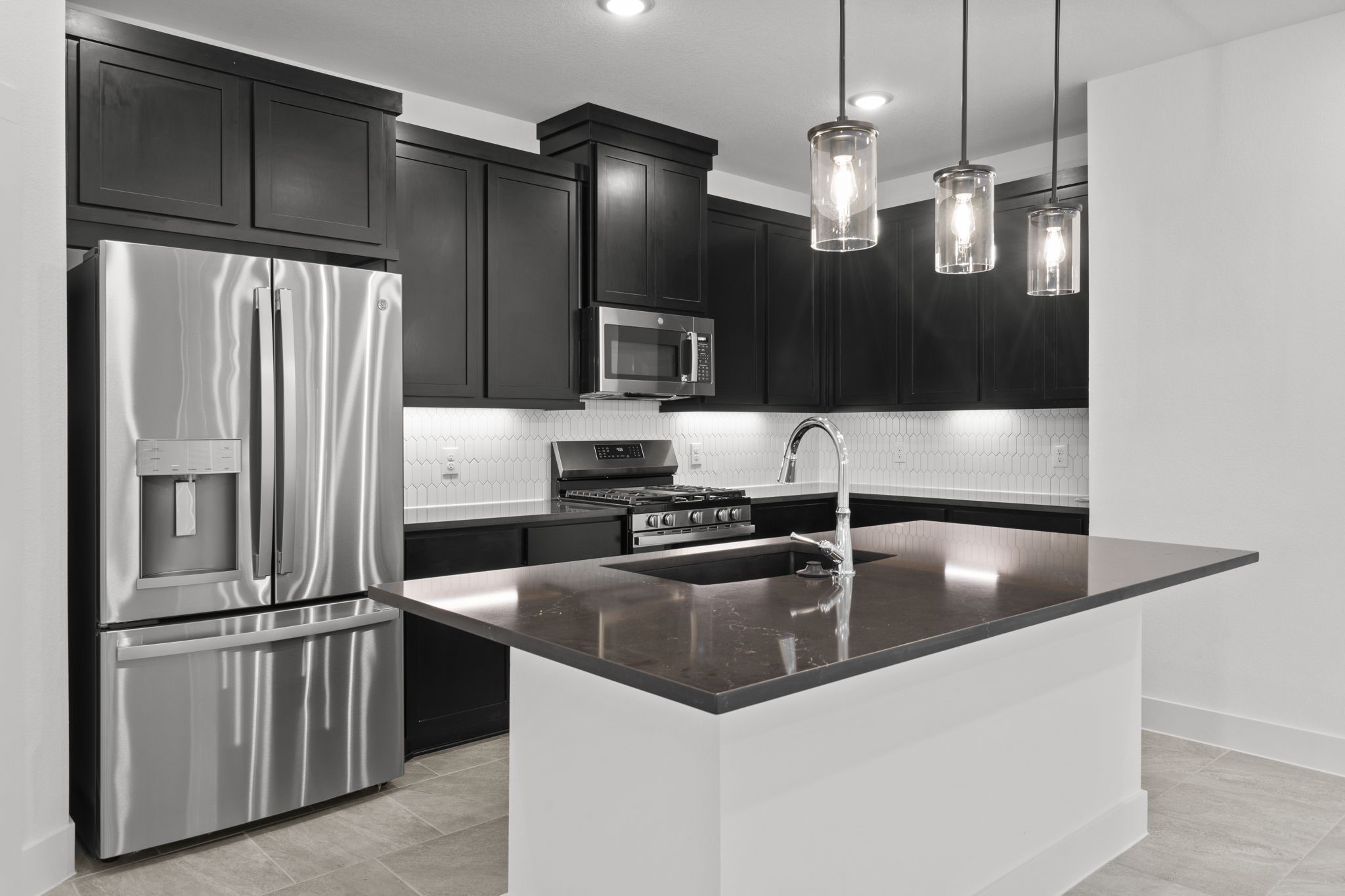 5231 Celestial Court Iowa Colony, TX 77583 - Photo 14 of 37 a kitchen with granite countertop a refrigerator and a sink