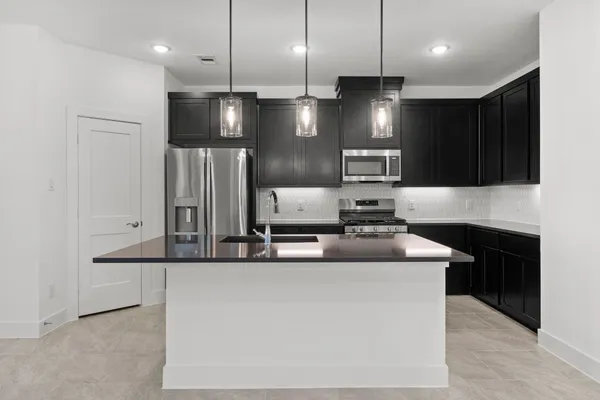 a large kitchen with stainless steel appliances kitchen island a large island in the center