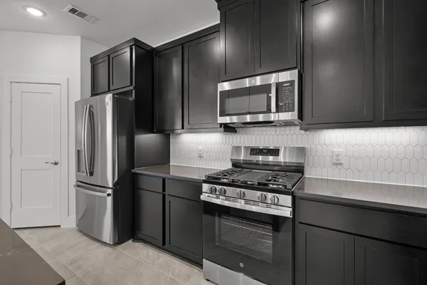 a kitchen with a refrigerator stove and microwave