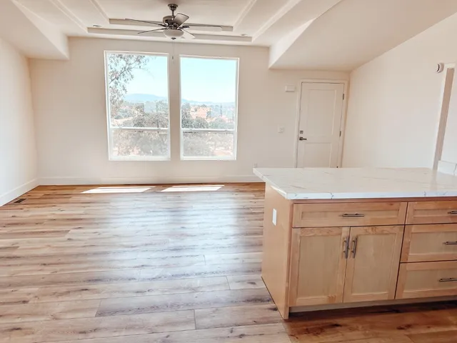 a view of room with wooden floor and fan