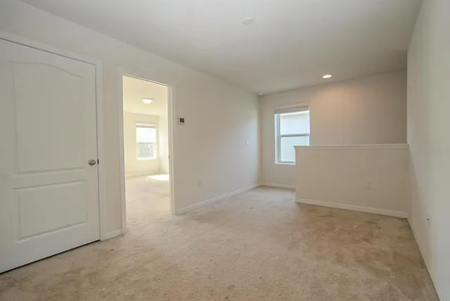 an empty room with windows and closet
