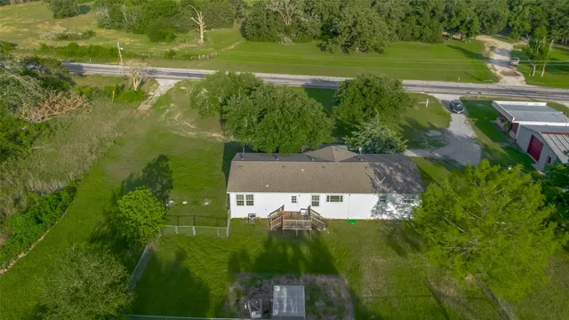 an aerial view of a house with a yard lake lake and green space