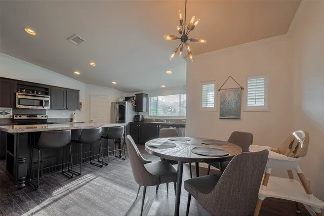a view of a dining room with furniture and wooden floor
