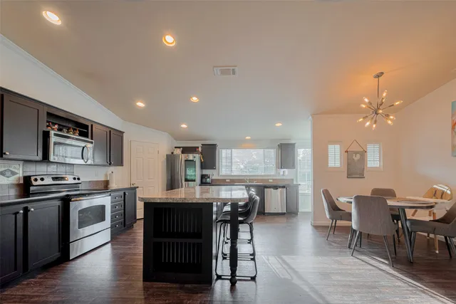 a view of a storage and utility room with wooden floor