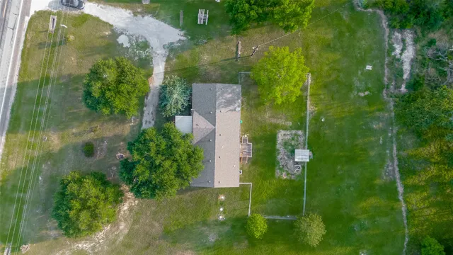 an aerial view of residential houses with outdoor space and lake view