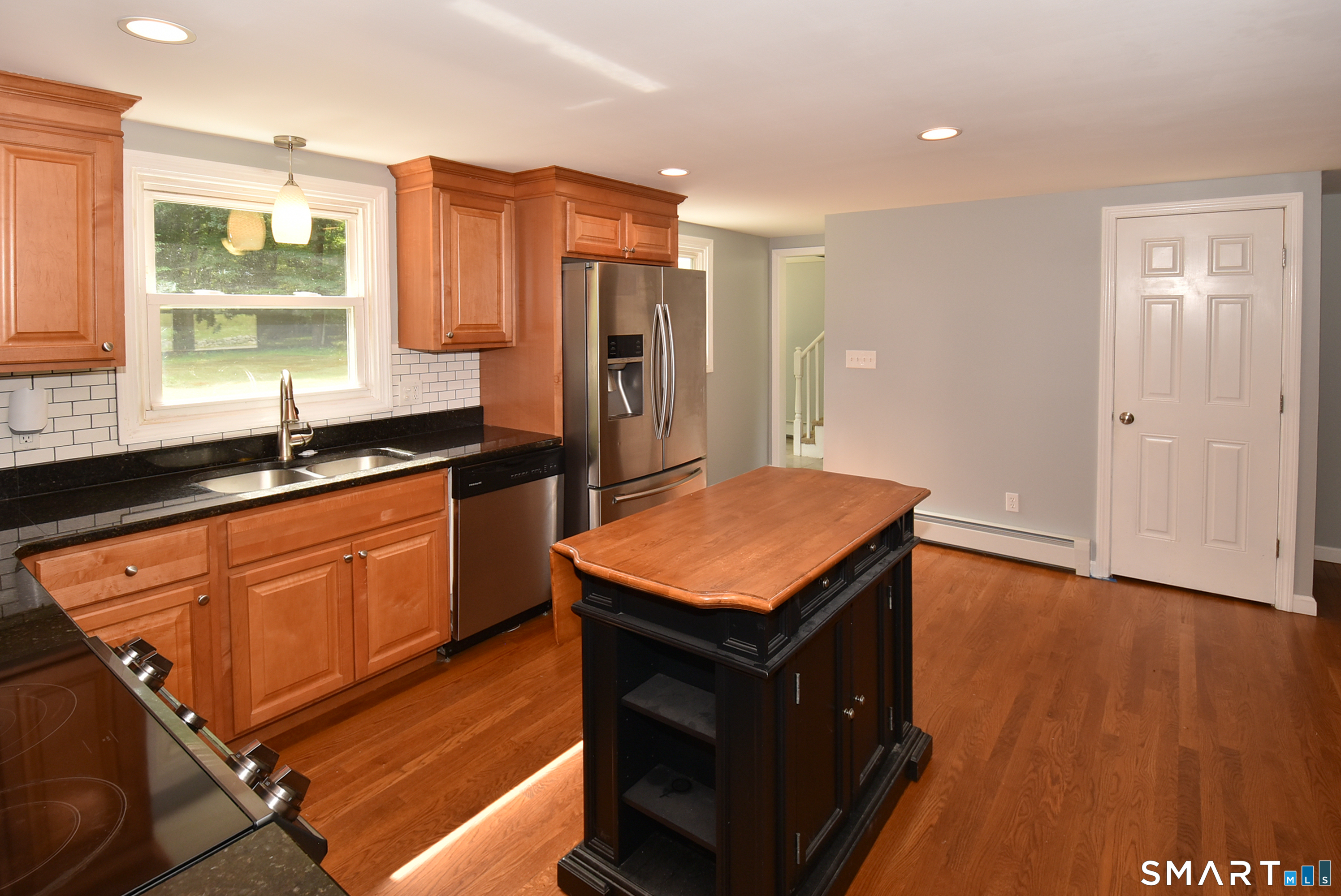 50 Doubleday Road Columbia, CT 06237 - Photo 11 of 29 This alternate kitchen view highlights the convenient transition to the mudroom, showcasing the home's functional, open-concept design.