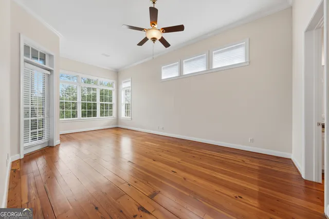 an empty room with a empty space and a ceiling fan