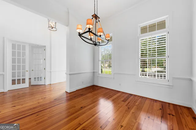 wooden floor in an empty room with a window and wooden floor