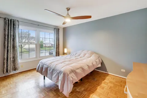 a bed sitting in a bedroom next to a window
