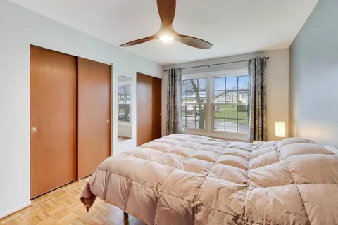 a bedroom with a large bed and a chandelier