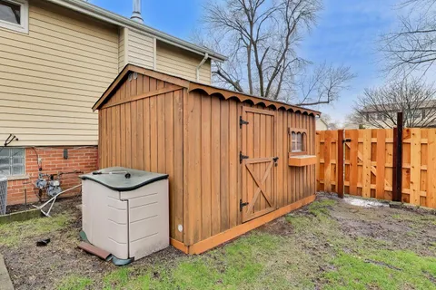 a backyard of a house with barbeque oven