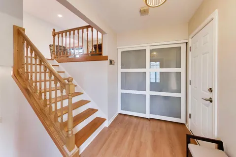 a view of an entryway with wooden floor