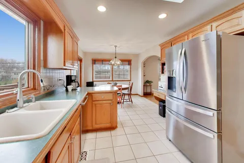 a kitchen with stainless steel appliances granite countertop a refrigerator and a sink