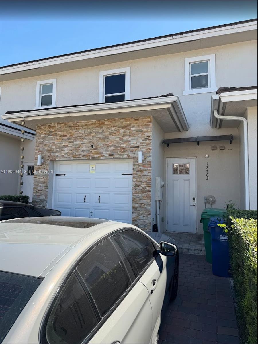 12762 Southwest 248th Street Homestead, FL 33032 - Photo 1 of 17 a bed sitting in a bedroom and balcony