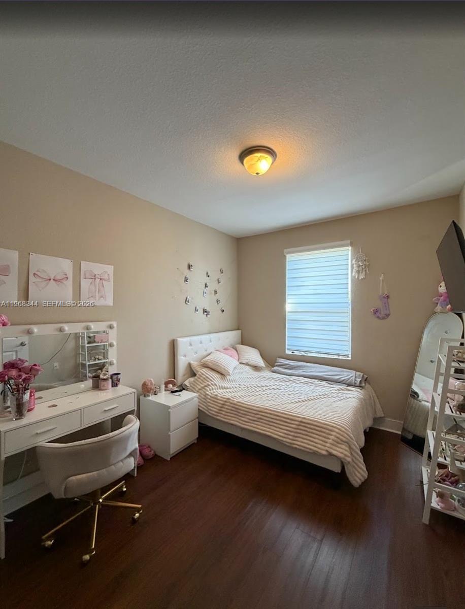 12762 Southwest 248th Street Homestead, FL 33032 - Photo 11 of 17 a bedroom with a bed and a window