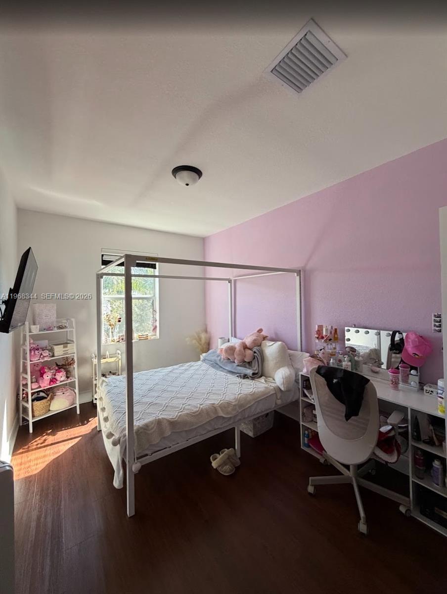 12762 Southwest 248th Street Homestead, FL 33032 - Photo 12 of 17 a bedroom with bed and window