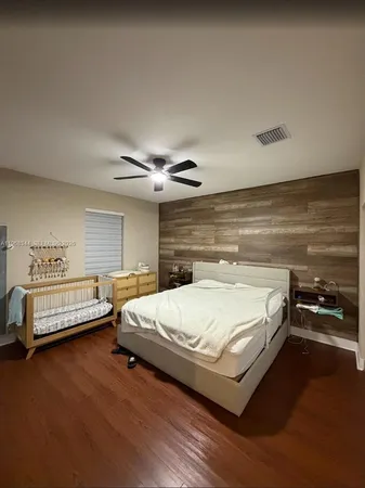 a bedroom with a bed and a night stand