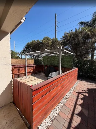 a view of a roof deck with wooden fence