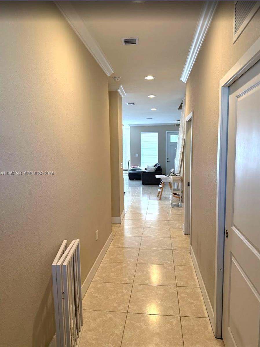 12762 Southwest 248th Street Homestead, FL 33032 - Photo 2 of 17 a view of a hallway with a couch and a window