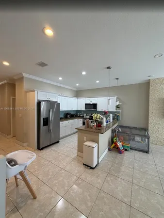 a kitchen with a sink and a refrigerator