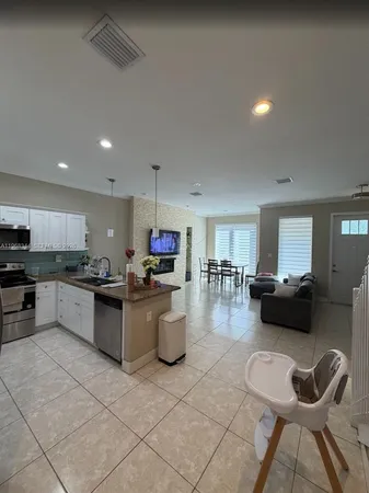 a kitchen with a refrigerator and a stove top oven