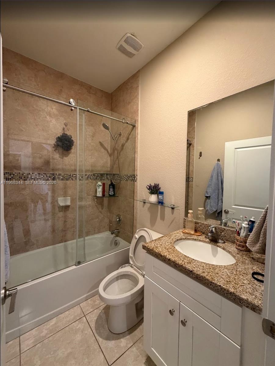 12762 Southwest 248th Street Homestead, FL 33032 - Photo 7 of 17 a bathroom with a granite countertop sink a toilet a mirror and shower