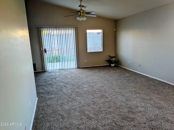 an empty room with windows and cabinet