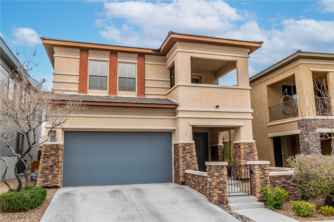 10350 Mystic Pine Road Las Vegas, NV 89135 - Photo 8 of 43 View of front facade with a garage, stone siding,