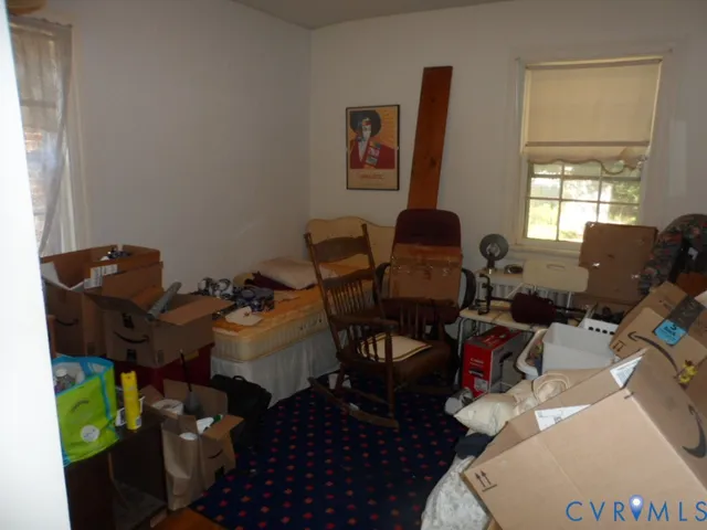 a bedroom with a bed window and dresser