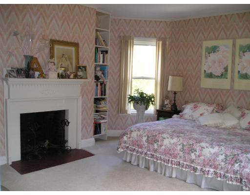 185 Buckminster Road Brookline, MA 02445 - Photo 4 of 5 a bedroom with a bed and a fireplace