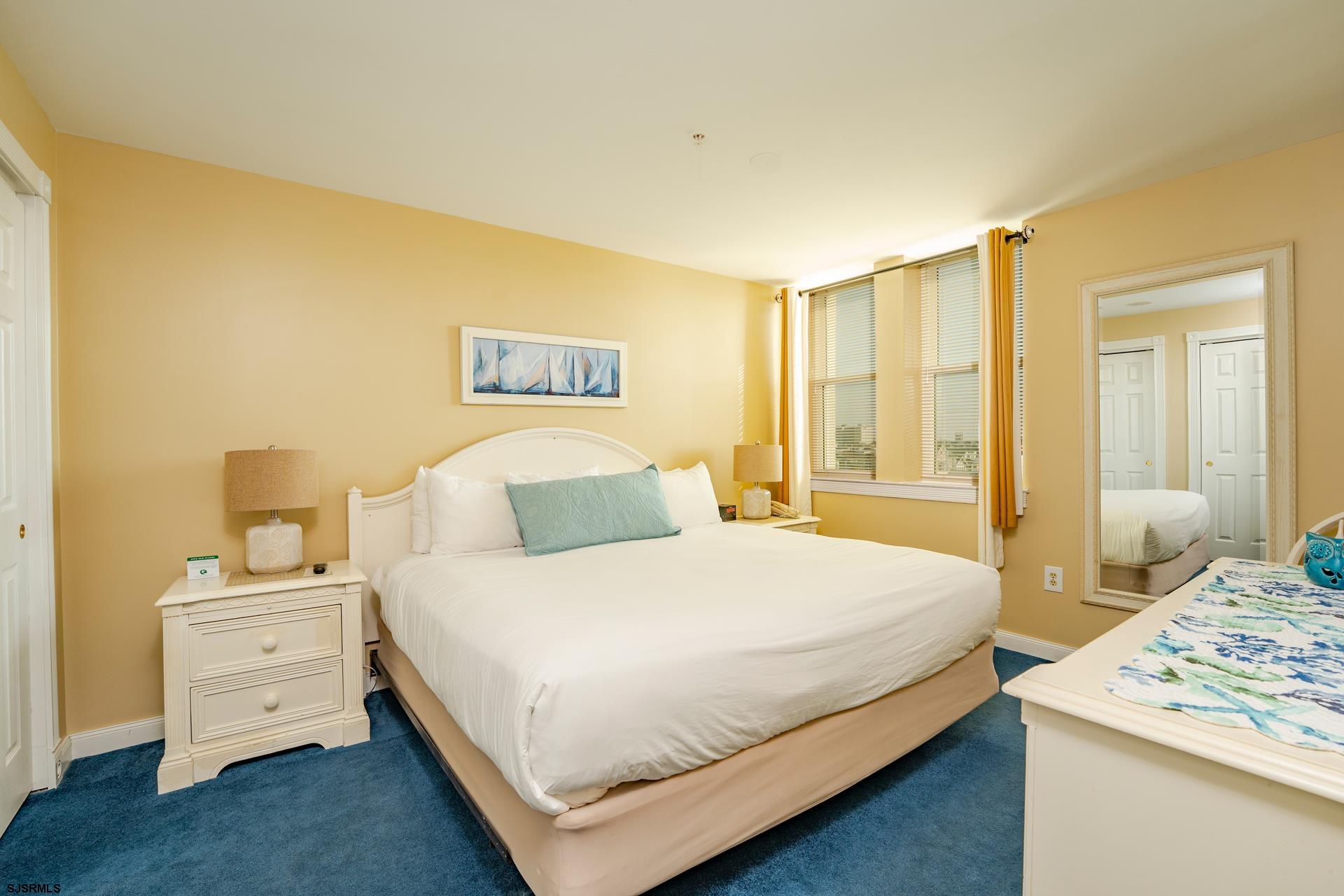 719 East 11th Street, Unit 510 Ocean City, NJ 08226 - Photo 13 of 16 a bedroom with a bed and wooden floor